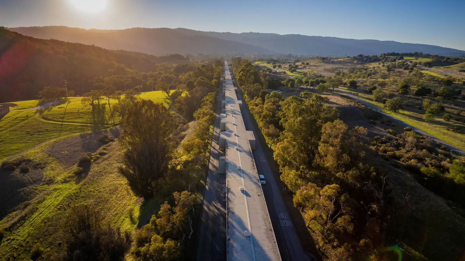 Aerial view along the SLAC linear accelerator toward the Bay Area hills at sunset